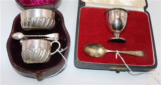 Victorian silver cream jug, sugar bowl and tongs (cased) and an egg cup and spoon (cased)